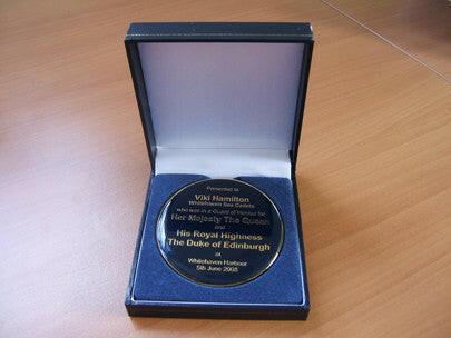 Custom designed medal in presentation box.