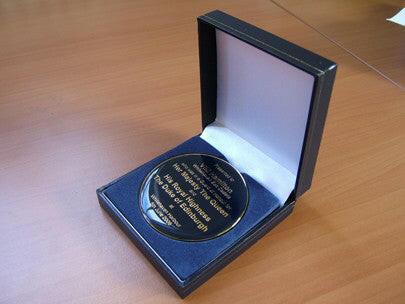 Custom designed medal with presentation box.